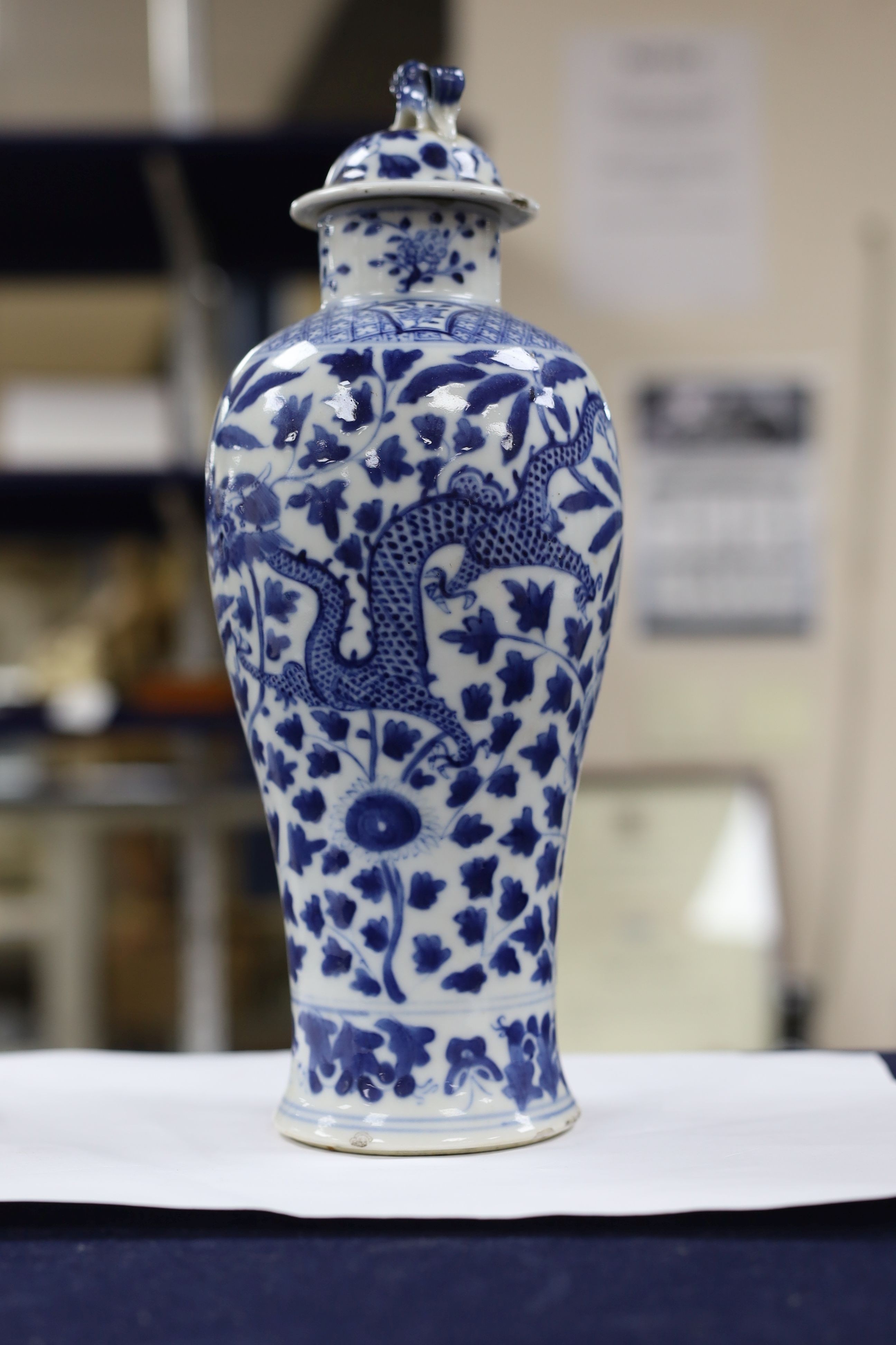 A pair of Chinese blue and white dragon vases and covers, circa 1900. 28cm